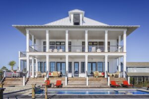 White house with a pool in front
